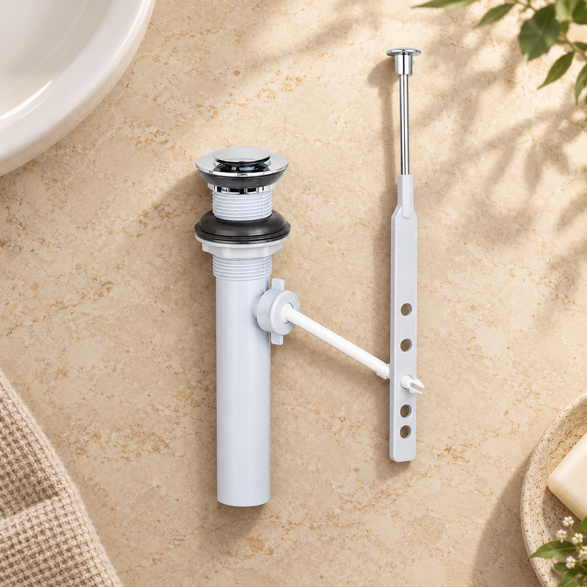 Desagüe automático cromado con varilla para lavamanos en una escena de baño. Componentes sueltos antes de instalar.