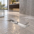 Rejilla rectangular inoxidable instalada en ducha