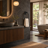 Toallero tipo aro negro con base rectangular instalado en baño