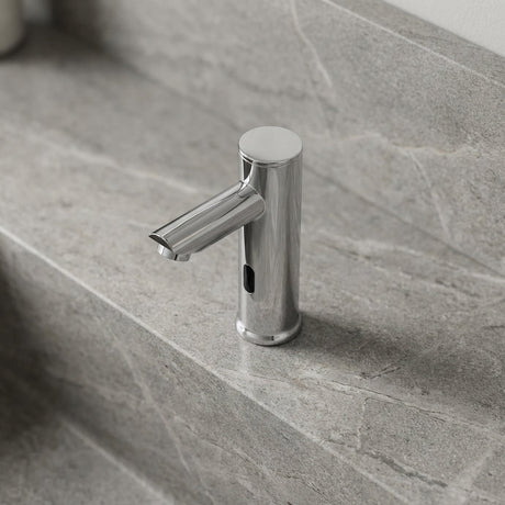 Detailed overhead view of a small chrome sensor faucet on textured bathroom countertop, highlighting its micro-texture and modern design.