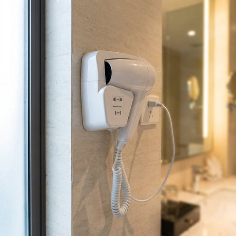 Close-up of modern wall-mounted hotel style hairdryer on sleek bathroom wall, emphasizing textured surface and integrated design.