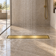 Rejilla invisible Oro cepillado instalada en ducha