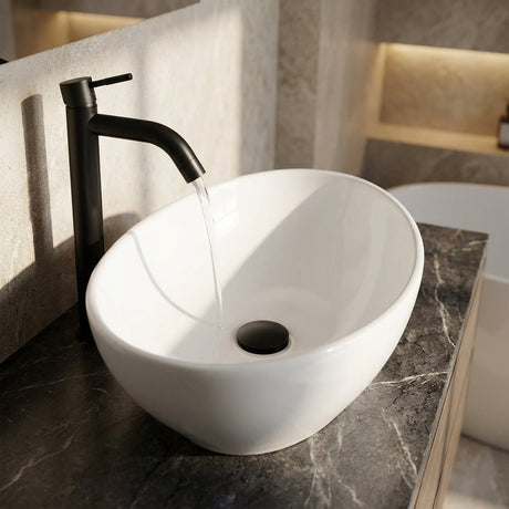 Close-up of black porcelain lavamanos with textured surface, highlighting curvature, sheen, and modern design on sleek surface.